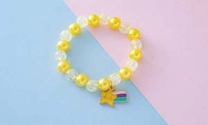 Detail of yellow beaded bracelet for children with smiling star and meteor pendants