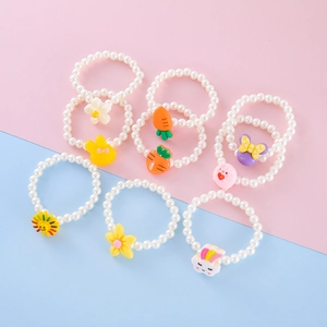 Detailed set of children's beaded bracelets with colorful resin cartoon animal pendants