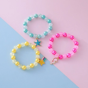 Set of three colorful beaded bracelets with seahorse, starfish, and star cartoon pendants