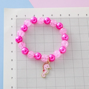 Kids seahorse charm bracelet with pink crackle beads and scale measurement