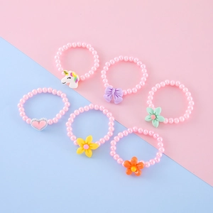 Detail of a 6-piece beaded jewelry set for kids with unicorn and flower charms