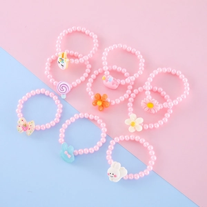 Close-up of colorful resin cartoon charms on beaded rings for children and toddlers