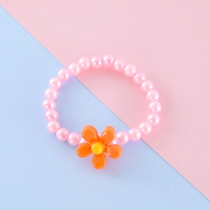 Close-up of pink beaded children's bracelet with bright orange floral resin charm