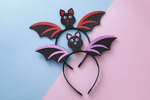 Detail of glitter bat headbands with sparkling sequins and moving eyes for Halloween decor