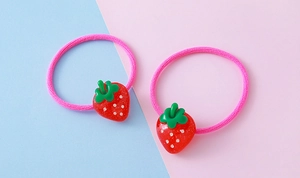 Detail of high-elasticity hair ties featuring cute resin strawberry pendants in rose pink