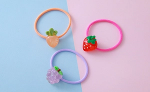 Detailed view of kids fruit elastic hair bands with resin carrot, strawberry and grape charms