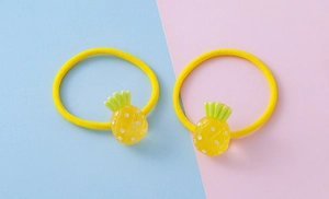 Detailed close-up of yellow pineapple hair ties with high elasticity for children's hair