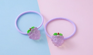 Close-up of elastic purple hair bands featuring cute resin grape pendants for children