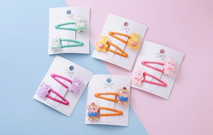 Detailed close-up of colorful resin cartoon animal hair clips for girls on display cards