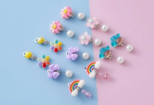 Detailed set of colorful resin clip-on earrings with rainbow, mushroom and flower charms