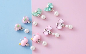 Detailed view of clip-on earring set with cartoon bows and resin pendants for kids