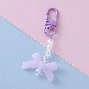 Detail of sweet purple bow keychain with acrylic beads and metallic lobster clasp