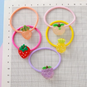 Five-piece kids fruit hair tie set featuring resin strawberry grape and pineapple charms