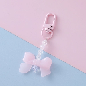 Detail view of pink acrylic bow pendant with faceted beads and metal clasp keychain