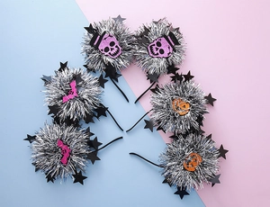 Detail view of 6-piece Halloween headbands with glittery pumpkins and bats on tinsel balls