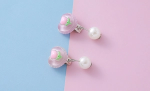 Detail of purple heart resin ear clips for kids with small peach and white pearl drop