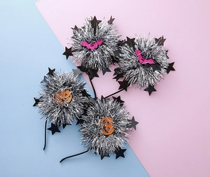 Close-up of Halloween headbands featuring silver tinsel and pink glittery bats