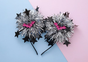 Detail of Halloween headband with silver tinsel balls, black stars and pink glitter bats