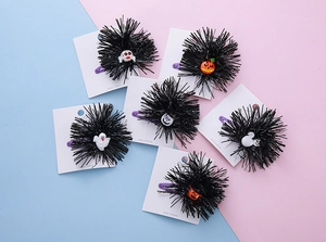 Detail of 6-piece Halloween hair clip set with pumpkin, ghost and spider motifs