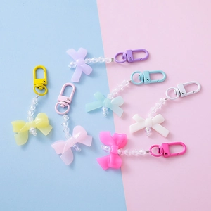 Set of colorful acrylic bow and pearl bead pendants in various macaron colors