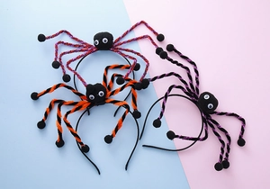 Detailed view of Halloween spider headbands with plush bodies and colorful glitter legs