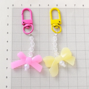 Cute candy color acrylic bow and pearl keychain charms for bags in pink and yellow