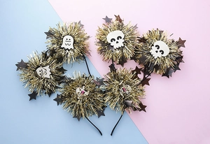 Detailed view of Halloween headbands with tinsel pom-poms, skulls and ghosts