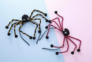 Detail of Halloween spider headbands featuring fuzzy bodies and glittery striped legs