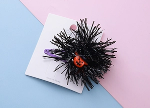 Detail of Halloween pumpkin hair clip with black tinsel and purple metal duckbill clip
