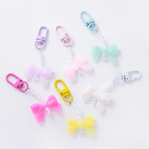 Colorful acrylic bow and pearl keychain charms set in six vibrant candy colors