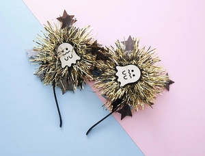Detail of Halloween headbands featuring gold tinsel pom-poms and cute ghost motifs