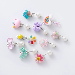 Colorful resin cartoon ear clips for kids featuring rainbow mushroom and crown charms