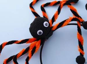 Detail of Halloween spider headband with fuzzy head and orange striped legs