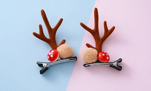 Detalle de pinzas para el pelo de renos navideños con setas rojas y pompones suaves
