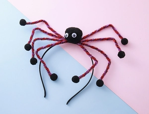 Detail of Halloween spider headband with fuzzy black body and red glitter legs
