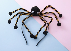 Detail of Halloween spider headband with fuzzy body and metallic gold legs on a colorful base