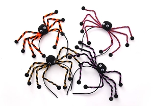 Detail of colorful Halloween spider headbands with plush pom-poms and googly eyes
