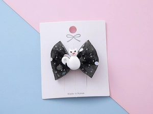 Détail de la pince à cheveux en tulle à paillettes avec fantôme en résine sur carte