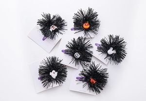 Detail view of 6-piece Halloween plush hair clip set with pumpkin and ghost motifs