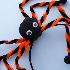 Halloween spider headband with orange and black striped plush legs and large googly eyes