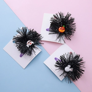 Halloween hair clip set with pumpkin and skull charms on purple metal barrettes