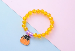 Detailed shot of kids Halloween beaded bracelet with black cat in pumpkin charm