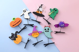 Detail of Halloween hair clips with glitter ghosts, pumpkins, and bats on metal springs