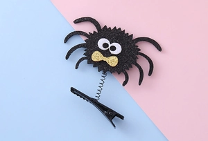 Detail of Halloween spider hair clip with black glitter, spring, and metal duckbill clip