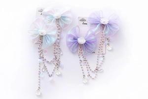 Detail of mermaid pearl fringe bow hair clips with shells and iridescent organza