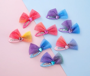 Detailed view of colorful glitter mesh heart hair clips for girls in various pastel shades