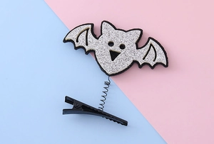 Detail of Halloween hair clip with silver glitter bat and elastic spring on metal base