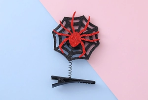 Detail of glitter spider hair clip with spring movement and black metal duckbill base