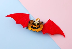 Detalle de horquilla de ala de murciélago roja con calabaza brillante y estrella
