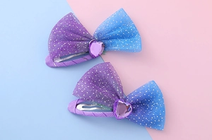 Detail of two-piece bow hair clips with blue purple mesh and sparkling silver glitter